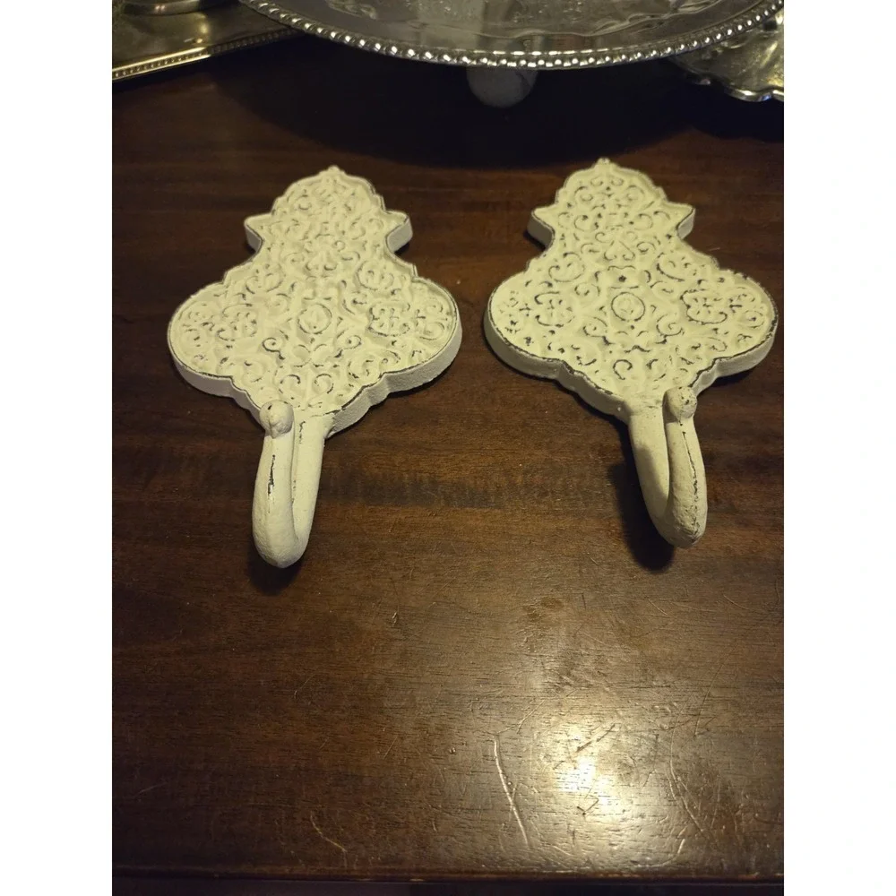vintage-style, shabby chic cast-iron wall hooks featuring an ornate, distressed
